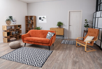 Interior of living room with pegboards, sofa and armchair