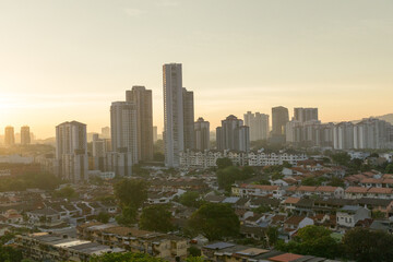 condos towering over terrace houses at sunset