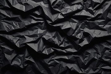 Black crumpled paper texture in low light background