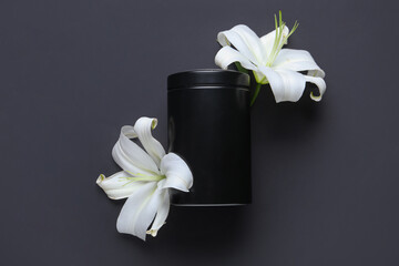 Mortuary urn and beautiful lily flowers on black background