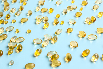 Fish oil pills on blue background
