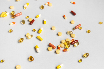 Fish oil capsules and different pills on grey background