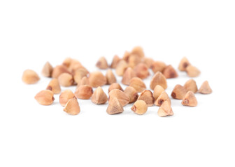 Many dry buckwheat grains isolated on white