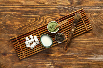 Composition with matcha tea, ingredients and accessories on wooden background