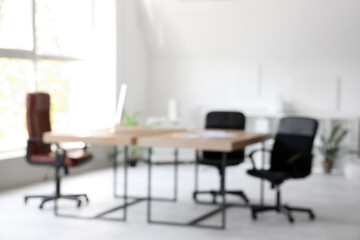 Blurred view of modern office with desks