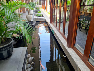 semi-outdoor layout, semi-open family room and living room with koi pond in the room. creates a...