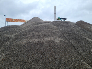 crushed stone for concrete mix. large piles of crushed granite or gravel in the concrete industry.