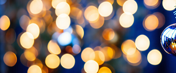 holiday illumination and decoration concept - garland bokeh lights over dark blue background