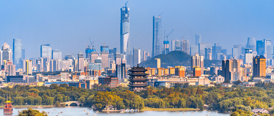 Scenery of Daming Lake in Jinan, Shandong, China and the CBD in the distant new area - obrazy, fototapety, plakaty
