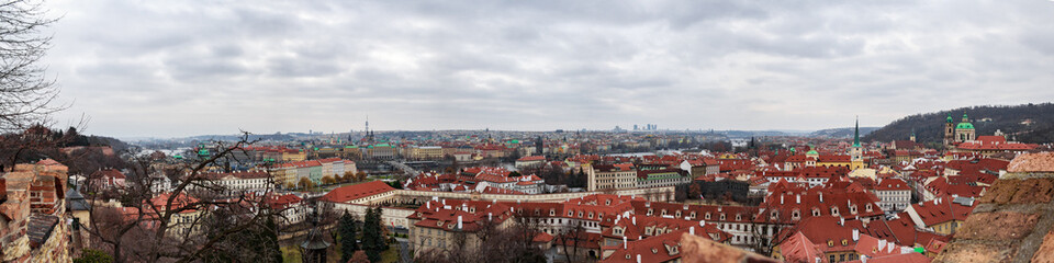 Fototapeta premium Panoramic view of the medieval city Prague during winter. You can see the tv tower, the Charles bridge, the Prague bridge and the Church of our lady from the distance. The wather was cloudy