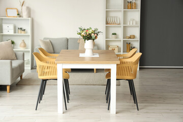 Interior of light room with flower vase on dining table