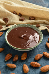 Composition with tasty melted chocolate on blue background