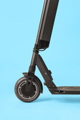 Black modern electric kick scooter on blue background