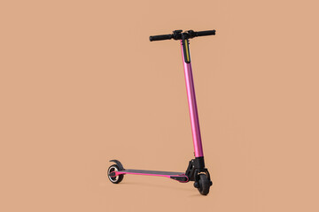 Pink modern electric kick scooter on brown background