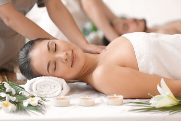 Obraz na płótnie Canvas Young Asian woman getting massage in spa salon, closeup
