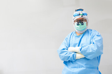 Male surgeon doctor inside white operating room.The surgeon is standing in cross arm position...