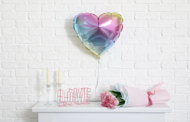 Mantelpiece with heart-shaped balloon, bouquet of tulips and candles. Valentine's Day celebration