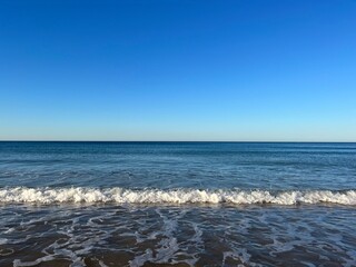 Blue seascape background, clear blue sky and blue sea horizon