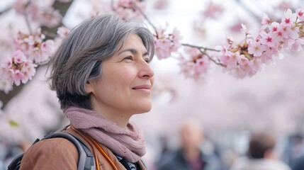 Fototapeta premium 桜の中を歩くシニア女性1