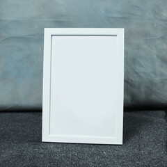 Blank picture frame on gray carpet in the room, stock photo