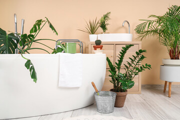 Interior of bathroom with green plants and sink