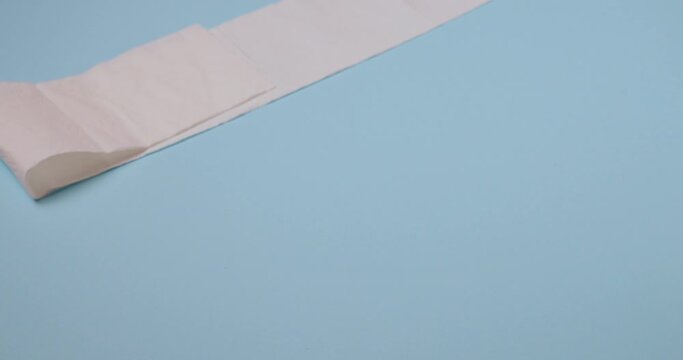 toilet paper roll bouncing on blue background