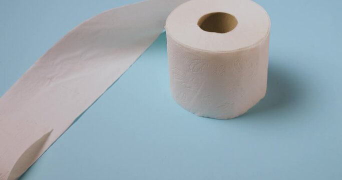 toilet paper roll bouncing on blue background