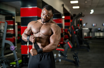 Fototapeta na wymiar Bodybuilder training his muscles. Shirtless strongman workout concept.