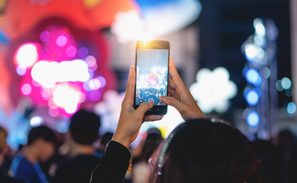 people holding smart phone and photographing in music festival concert, party event background concept	
