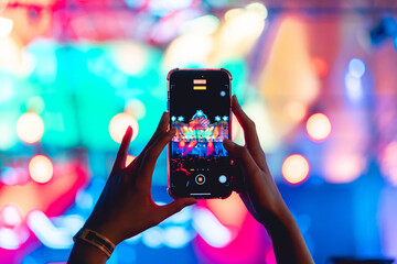 People holding smart phone and recording and photographing in music festival concert, event...