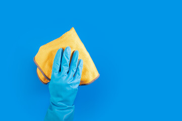Cleaning supply, hand holding rag, tool for cleanup, sanitary service, blue background