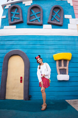 Asian beautiful woman happy in amusement park wearing white clothes and red skirt during daytime, fairytale world