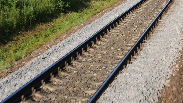 railway on gravel. View from window of moving passenger train