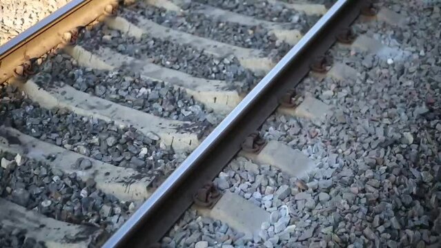 Railroad on gravel. View from window of moving passenger train