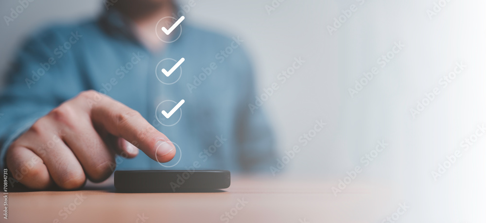 Poster Businessman touching to screen of smartphone to tick correct mark to approve document and project concept.