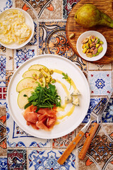 salad with jamon pear and cheese, view from above, without people, close-up