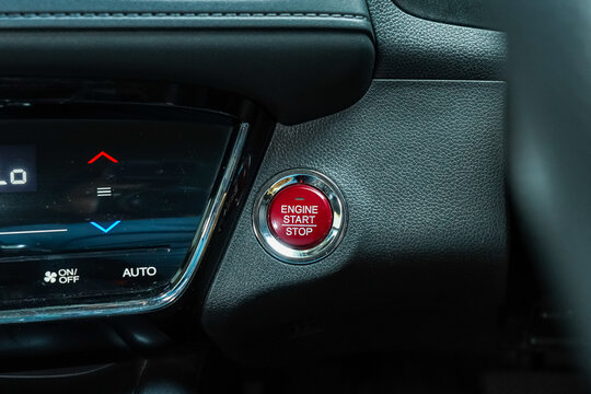 Engine Start Stop button on modern car. Black leather textured dashboard