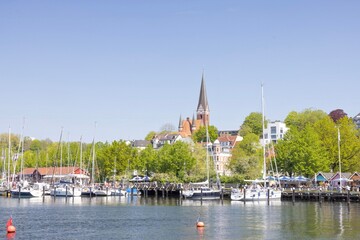 Happy walking along in Flensburg street (harbor) with old boats, Flensburg, Germany