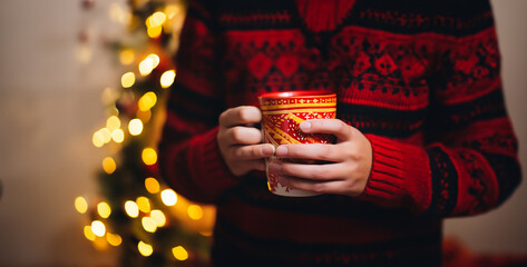 person holding a cup of tea, A professional photo of a festive Christmas coffee cup