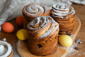 Easter cakes kraffins with raisins, candied fruits, sprinkled with powdered sugar. Close-up of homemade cake. Cruffin. Easter eggs
