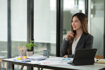 Businesswoman talking to customers online together at the office.