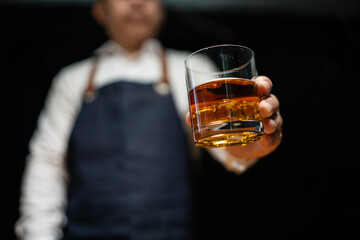 Barman pouring whiskey whiskey glass..