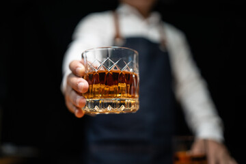 Barman pouring whiskey whiskey glass..