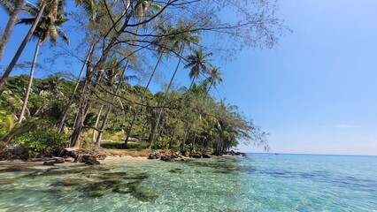 A fantastic beach in Koh Kood in Thailand with crystal clear water on a sunny day.