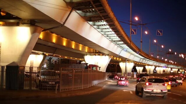 many cars moving at road near overpass at dark night