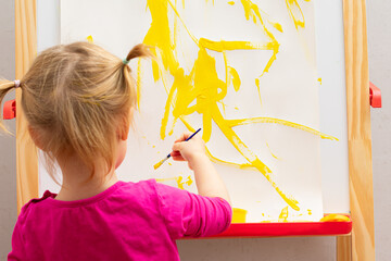 Little girl drawing on board at home. Childhood