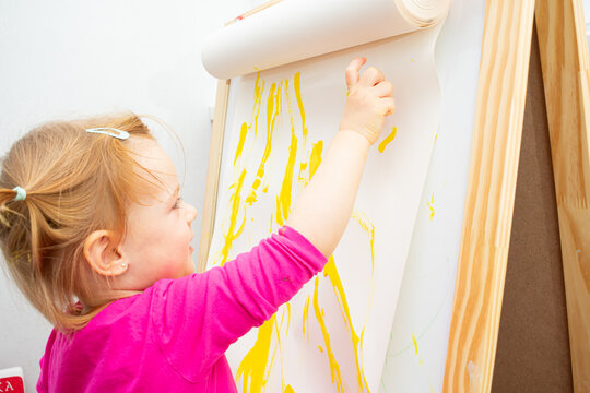 Cute little girl with painted hands. Education, school, art and painting concept