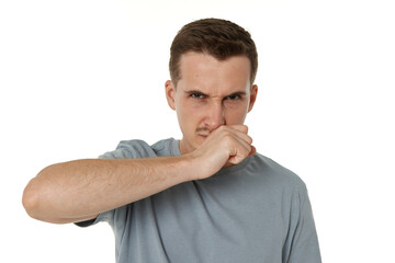 young man shows her toung, feels disgust on white background.