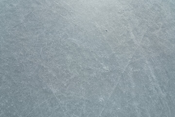 Scratched ice at the ice rink as texture or background for winter composition
