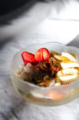 Homemade yogurt topped with sauce, fresh fruit and lots of grains.